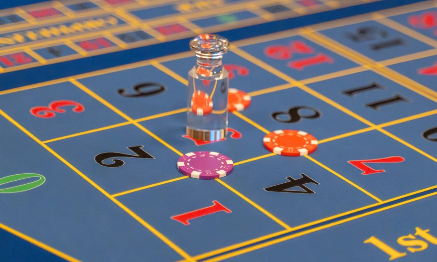 The winning number marker set on a blue Roulette layout, chips placed across the grid